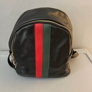 Black pleather book bag with red/green stripe and gold accents